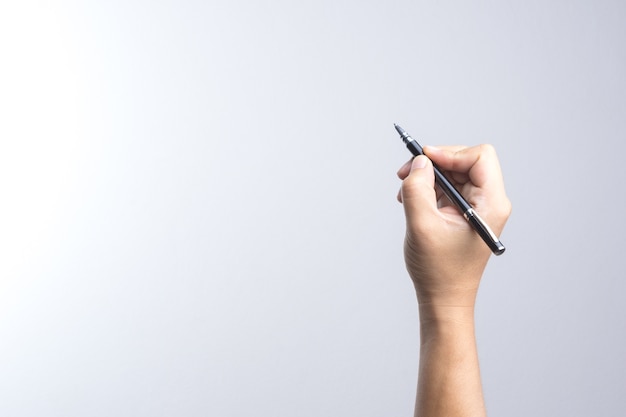 Hand holding a pen for signing or writing