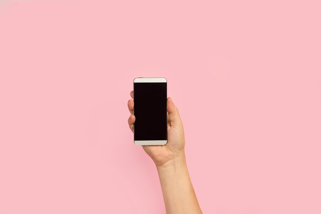 A hand holding a phone with a blank screen