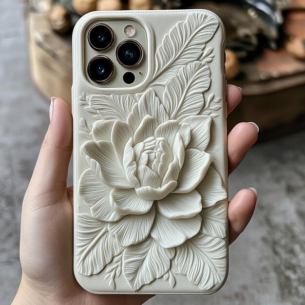 Photo a hand holding a phone with a flower design on it