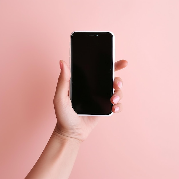 A hand holding a phone with a pink background.