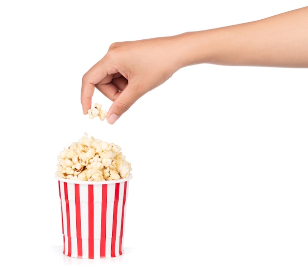 hand holding Popcorn in striped bucket isolated on white background