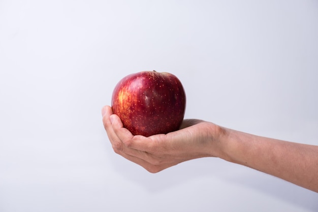 Hand holding a red apple fruits and vegetables healthy living lifestyle