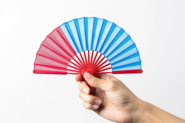 Photo hand holding red and blue plastic fan isolated on white