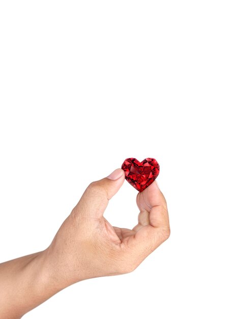 Hand holding red heart shaped diamond isolated on white background