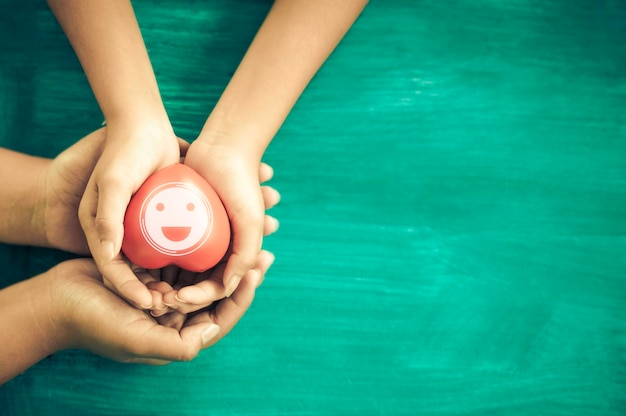 A hand holding red heart with heart waveShe is hand holding it on blue backgroundheart healthhappy volunteer charityThe photo shows the principle of caring and good health