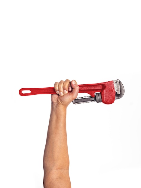 A hand holding a red wrench over a white background