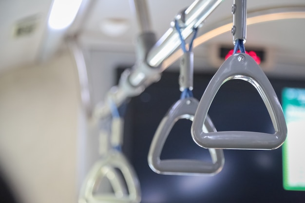 Hand holding safety straps, Hanging handle, plastic grab handle inside the public transport