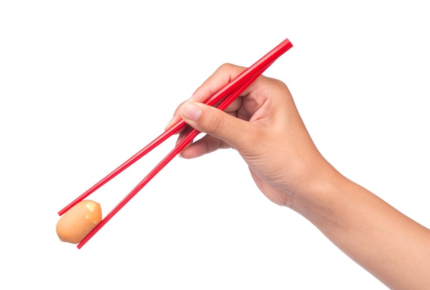 hand holding Sausage by chopstick isolated on white background