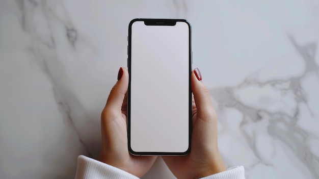 Hand holding a smartphone with a blank screen on a marbled background