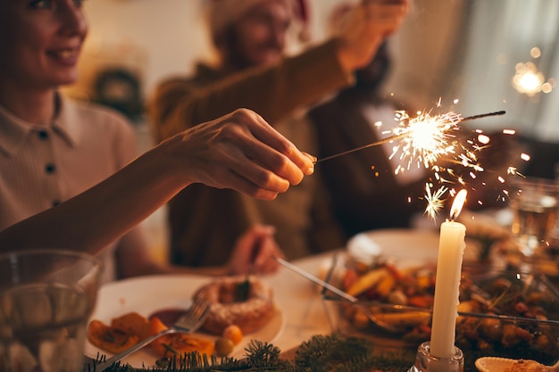 Hand Holding Sparkler over Table