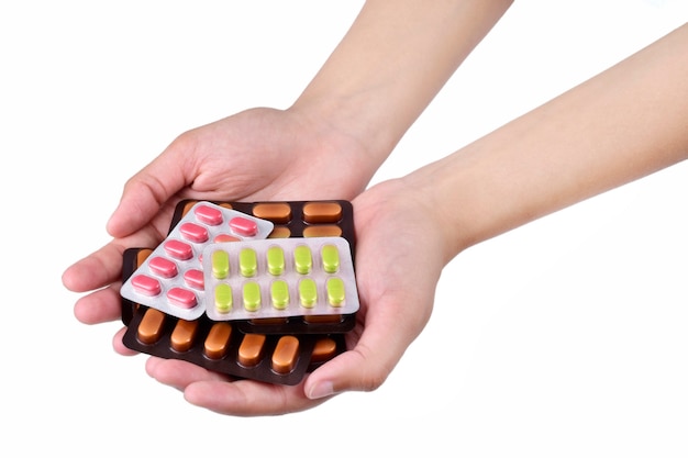 Hand holding stack of medicine isolated on the white background