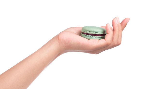 hand holding Sweet and colourful french macaroons or macaron isolated on white background