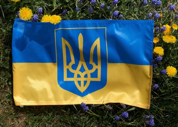 Hand holding in Ukrainian flag on yellowblue background War of Russia against Ukraine