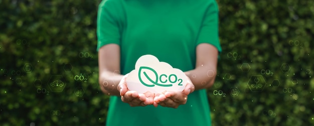 Hand holding with cloud for co2 ESG and net zero energy saving concept save our planet world environment day world earth day sustainable development and green business