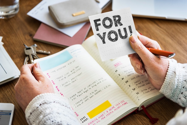 Hand holding For you on a sticky note