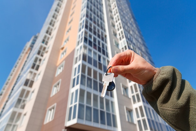 Hand holds the keys to a new apartment