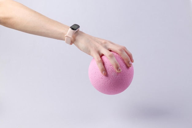 Hand holds a pink balloon on a gray background Minimalism fresh idea concept