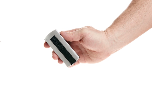 Hand holds a remote control on a white background template for designers