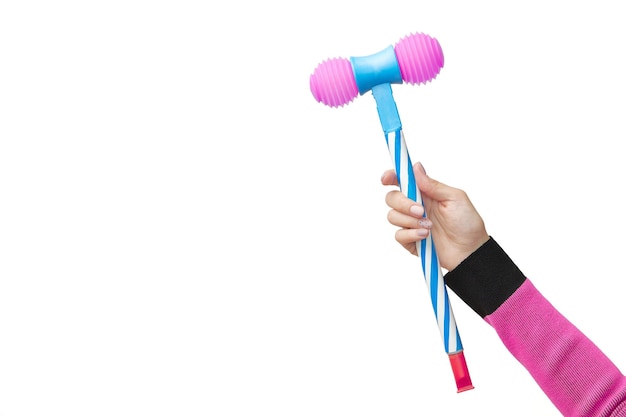 A hand holds up a pink and blue toy hammer against a white background