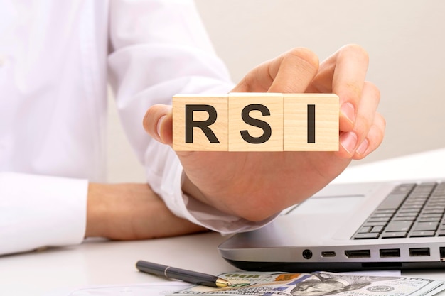 Hand holds wooden cubes with inscription rsi white background Relative Strength Index concept