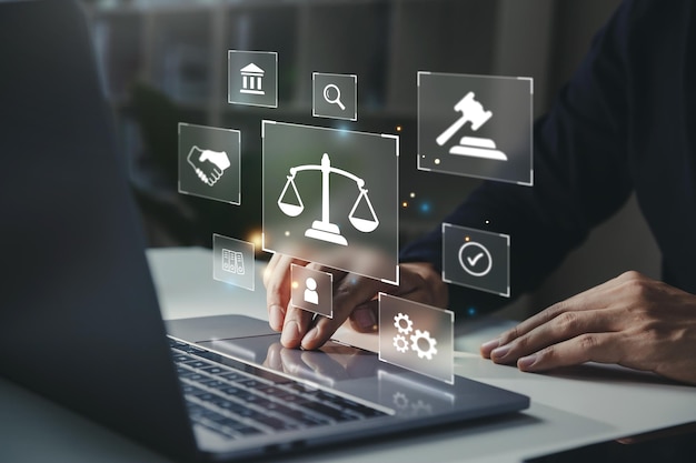 Hand of human with legal services icon on laptop screen