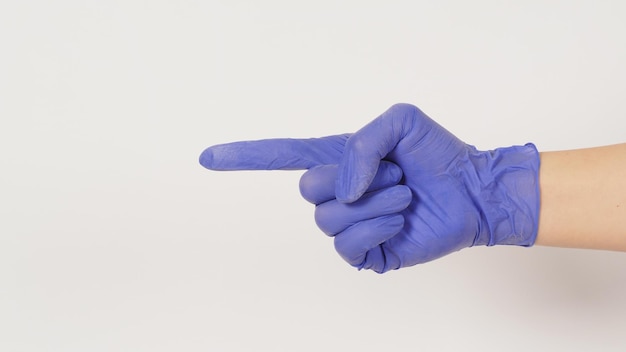 Hand is doing pointing finger side view hand sign on white background Hand wear violet or purple