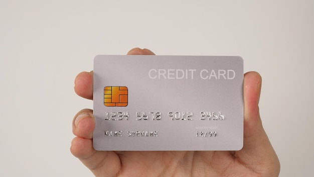 Hand is hold silver credit card on white background