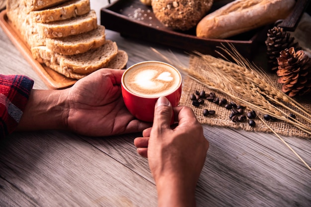 Hand is holding a red cup of coffee. concept still life