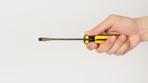 The hand is holding a Screwdriver isolatedxA on white background