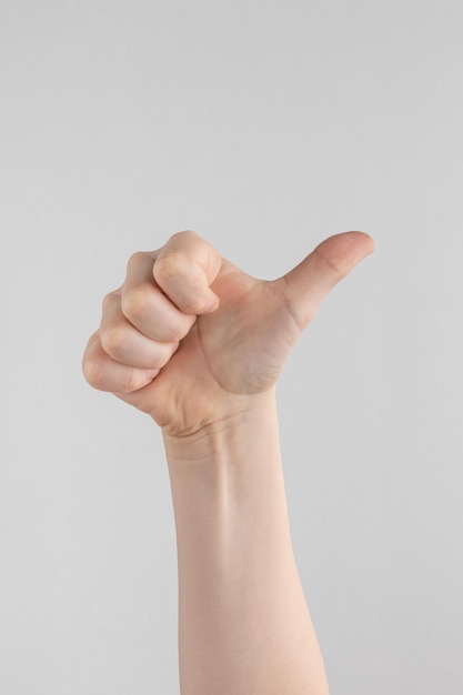 Hand of kids or child hand showing thumbs up Isolated on white and gray background