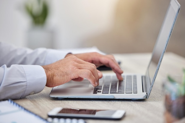 Hand laptop and research with the hands of a business man typing an email on a keyboard in the office at work Computer internet and writing with a male employee at work on a report or project