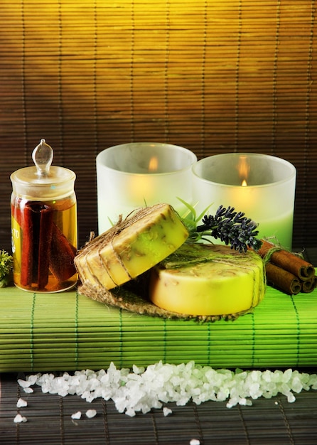 Hand made soap and candles on bamboo mat background