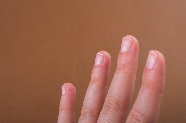 Hand making a gesture on wooden background