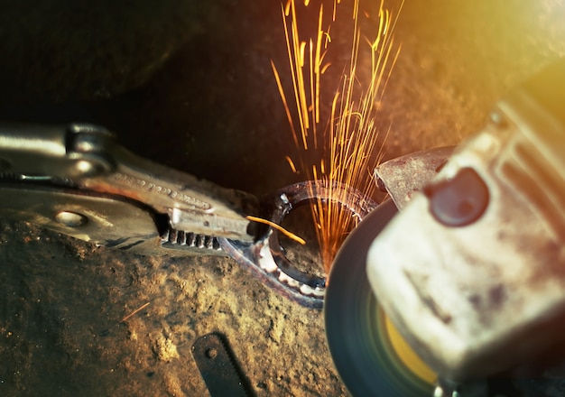 Hand of man with steel cutter tool blurred on black background