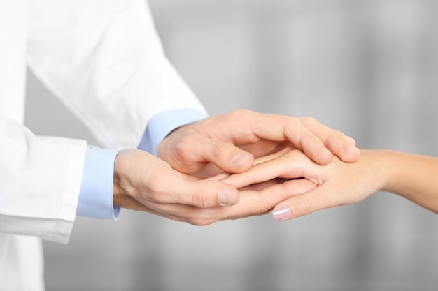 Photo hand of medical doctor carefully holding patients hands