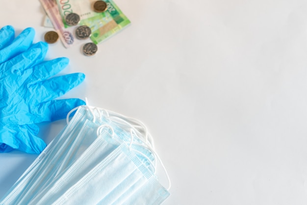 Hand in medical glove is showing protective mask