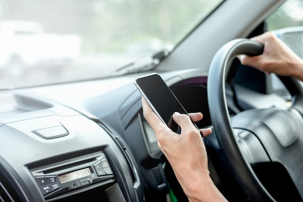 The hand of men are using smartphones in cars