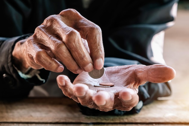 Hand old man begging for money because of the hunger vintage tone