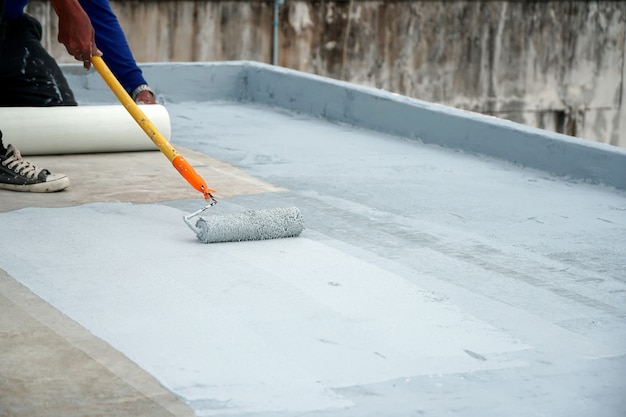 Hand painted gray flooring with paint rollers for waterproof reinforcing net