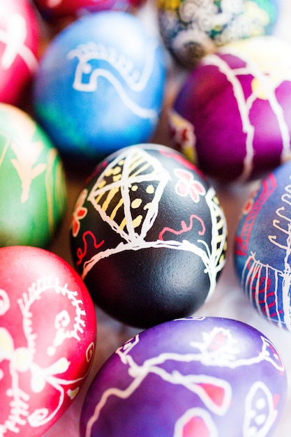 Hand painted Ukrainian Easter eggs decorated with folk designs using a wax resist method.