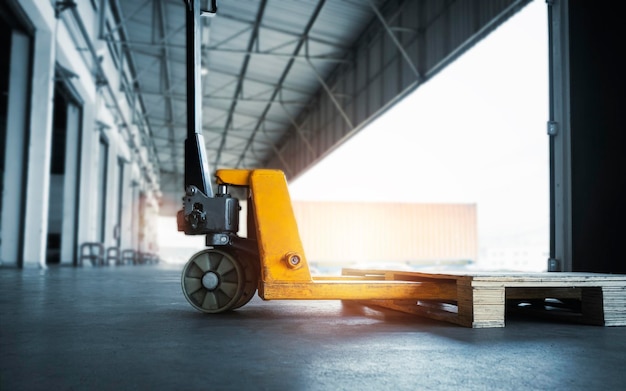 Hand Pallet Truck with Wooden Pallet Rack in The Warehouse