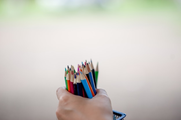 Hand and pencil pictures, green background 