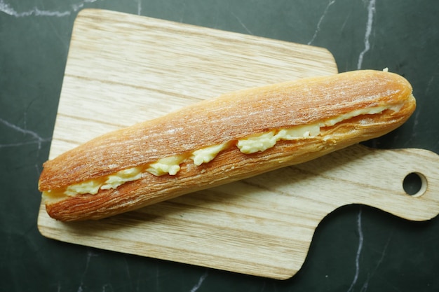 Hand pick a cream butter bread from a table