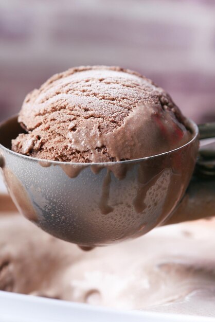 Hand picking ice cream with a spoon from a bowl