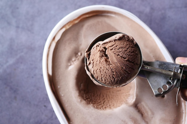 Hand picking ice cream with a spoon from a bowl