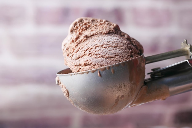 Hand picking ice cream with a spoon from a bowl