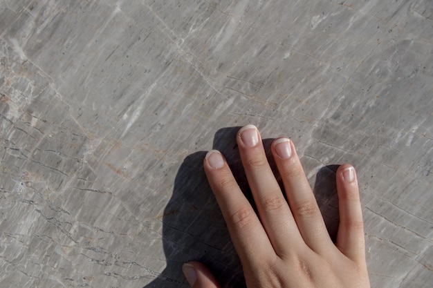 Hand on piece of marble stone