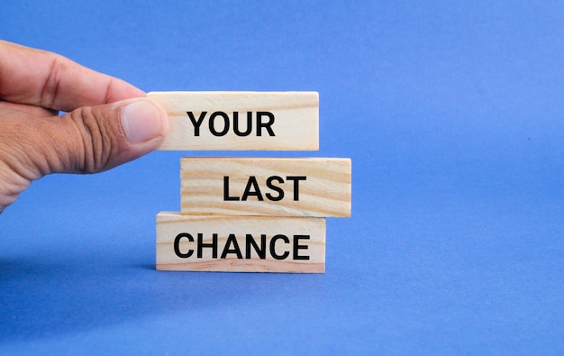 hand placing a stick with the words Your last chance. last chance concept for you