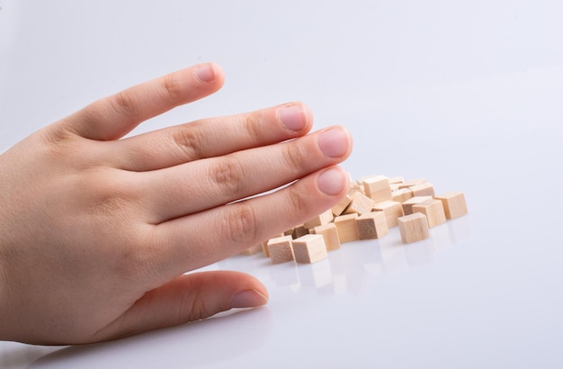 Hand playing with wooden toy cubes as educational games