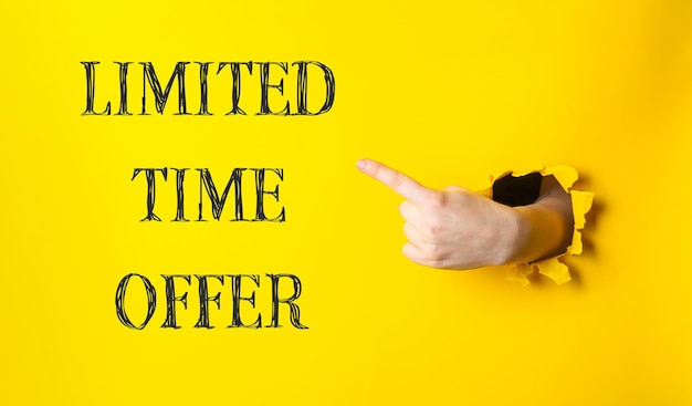 Photo a hand pointing to a yellow background with the words limited time offer